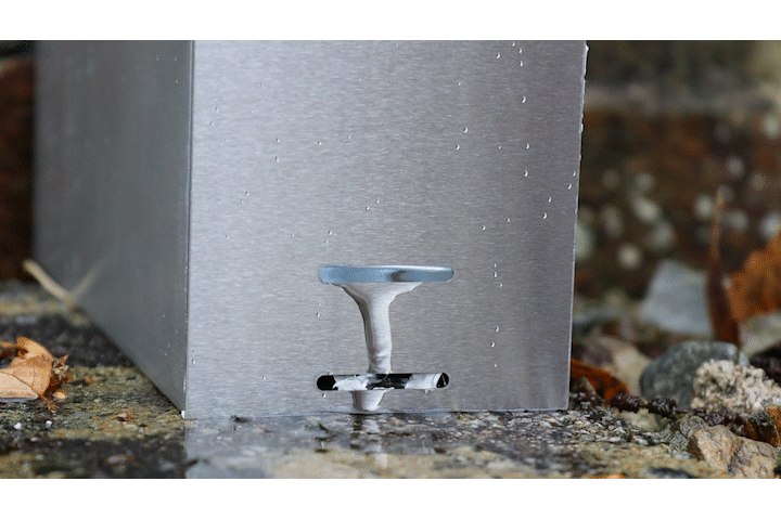 Close-up detail of new PosiGlaze drainage slot end cap in brushed stainless steel showing integrated drainage slot