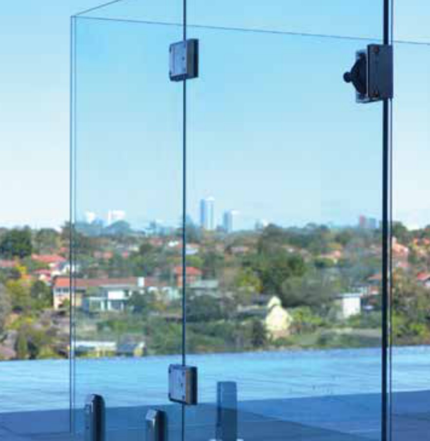 A sleek, modern glass pool fence latch